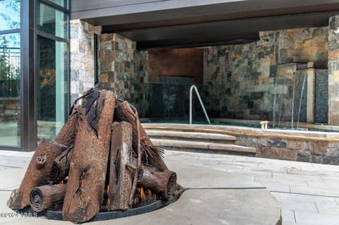 Pool hot tub area with fireplace