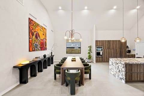 With 22 foot high ceilings, the dining/kitchen area is the heart of the home.