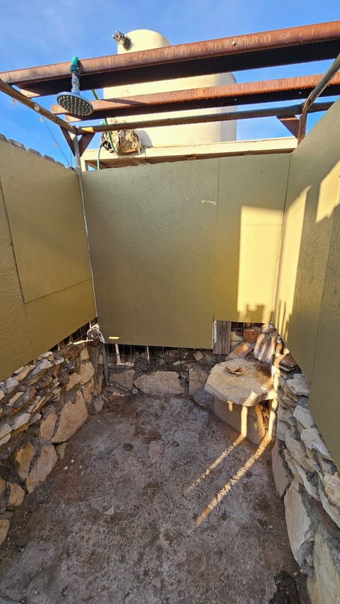 Outdoor shower, not heated. May heat water in kitchen for bathing old fashioned