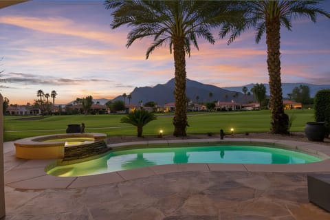 Backyard oasis w/ glowing pool & mountain views, perfect for relaxing at dusk