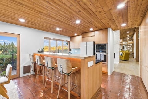 Open-concept kitchen and dining area with inviting bar seating.