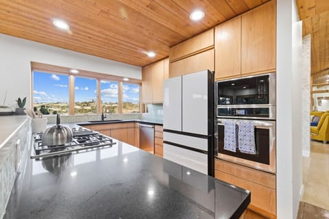 Bright, modern kitchen with stunning panoramic views — the perfect space to cook, unwind, and enjoy your stay.