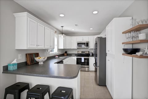 Full-service kitchen with bar stool seating 