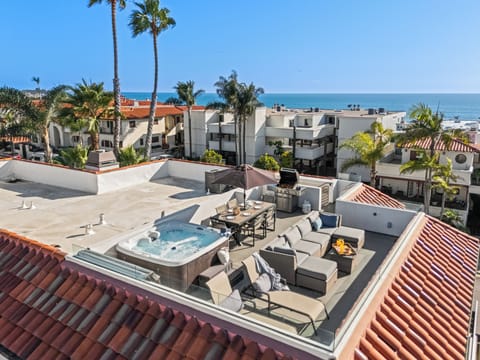 Private rooftop deck with hot tub, ocean views, and coastal breezes — the ultimate Newport Beach escape. (Unit 1)