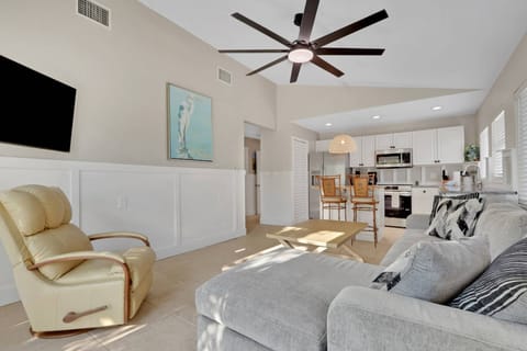 The open living space combines living room, eating bar, and kitchen.