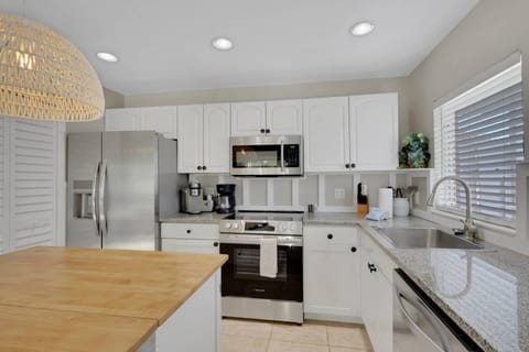 The beautifully updated kitchen is well equipped with upgraded appliances including oven, dishwasher, refrigerator/freezer and microwave.