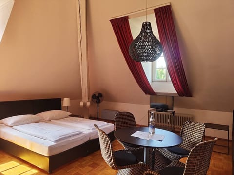 Bright loft studio with bed and dining area in Konstanz
