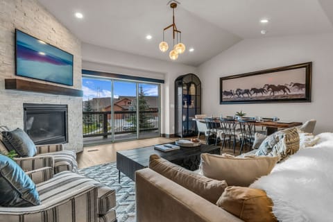 Living room (main level): Gas fireplace, Smart TV (50”), sectional seating
