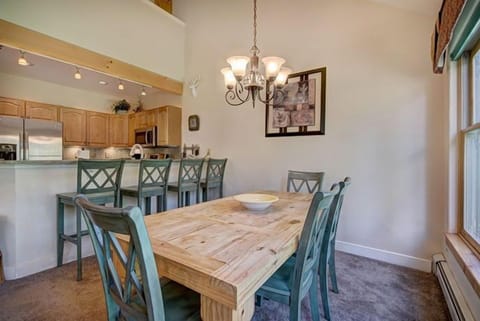 Stylishly appointed and open to the kitchen, this dining nook invites leisurely brunches and evening gatherings, surrounded by the natural beauty of Keystone.