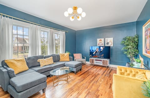 Bright and open living area with comfortable furnishings and a Smart TV.