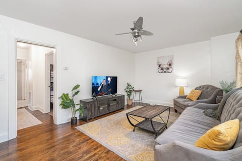 Bright and open living area with cozy furnishings and a smart TV.