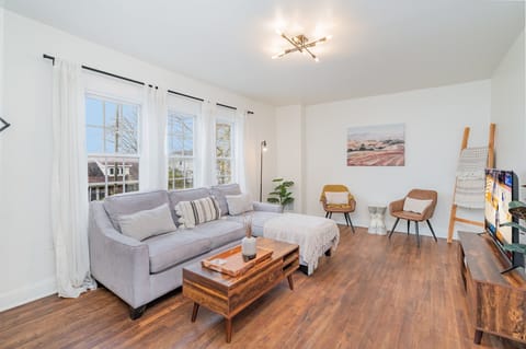 Bright and open living area with cozy furnishings and a smart TV.