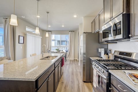 The kitchen features sleek, new appliances and everything needed for everyday meals.