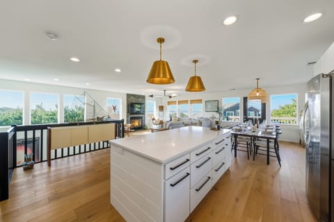 Living area with ocean views. Dining area, full kitchen, Living room with fireplace and access to the deck with outdoor dining table.
