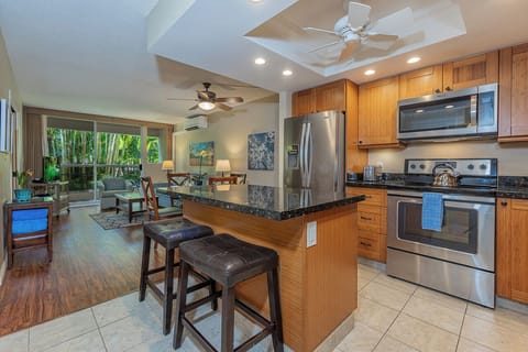 Modern kitchen featuring a full-size fridge, microwave, and dishwasher