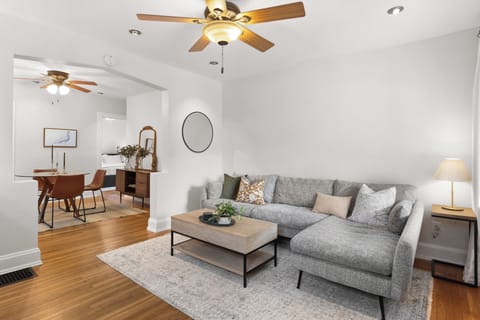 Living room with couch, coffee table, Roku TV, and two cabinets for storage.