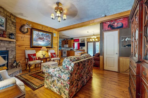 Rustic charm awaits with floral decor and a warm stone fireplace. Perfect for relaxation!