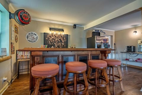 Bar area awaits! And, sip cocktails at this stylish bar with fun decor and inviting seating!