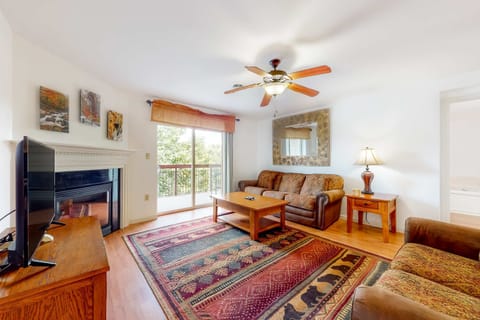 Relax by the fireplace with views of nature and stylish decor inviting adventure!