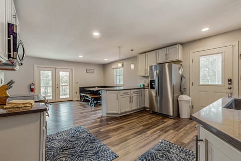 Bright open-concept kitchen with stainless appliances and plenty of space. Perfect for cooking family meals, group stays, and relaxing cabin vacations with modern comforts.