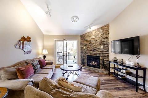 Enjoy evenings by the stone fireplace with stunning outdoor views!