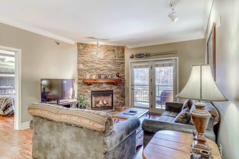 Cozy living room retreat awaits! Enjoy scenic views with a stone fireplace and spacious seating!