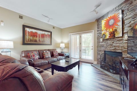 Enjoy the warmth of a stone fireplace and vibrant art in this inviting space!