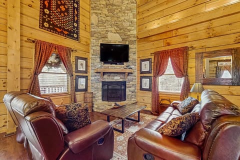 Living Room, relax by the stone fireplace and enjoy mountain views from this inviting retreat!