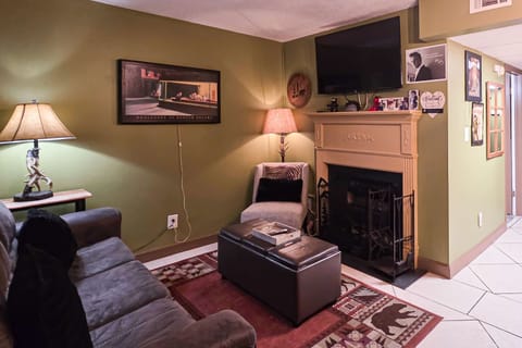 Your Living Room Retreat awaits! Relax by the fireplace in this artsy haven with striking decor and ambiance!