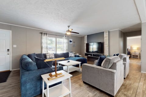 Living Room, sunlit space with plush seating, perfect for relaxing and watching movies together!