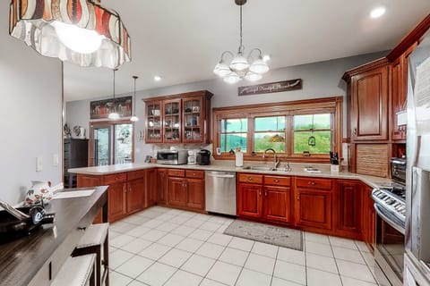 Whip up culinary masterpieces in this sunlit space with elegant wood cabinetry!