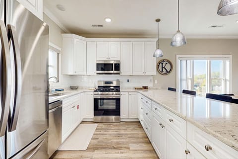 Experience culinary bliss in this bright, stylish kitchen with stunning views and modern appliances!