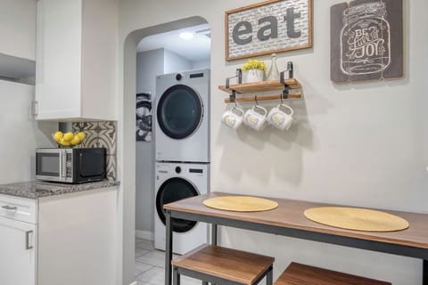 Kitchen and brand new washer and dryer.