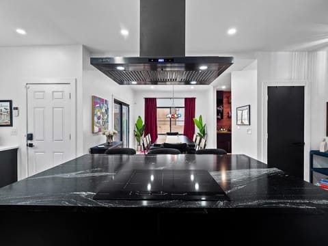 Bold entry hallway w/ striking colors & art that sets the mood.