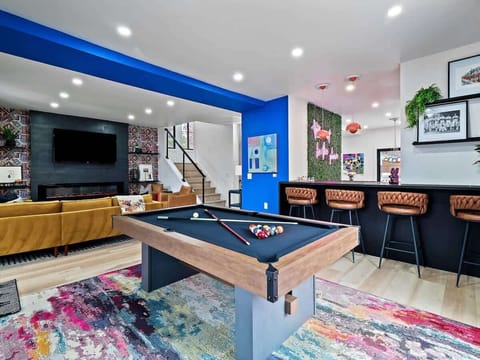 Bright game room w/ pool table & foosball for laid-back hangs.