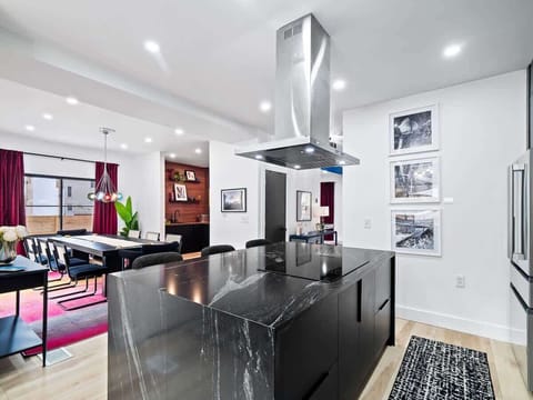 Sleek dining space flowing into a bright kitchen for easy group meals.