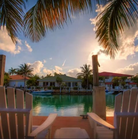 Relax on the dock with a cool drink, throw a line in too, catch a snapper.