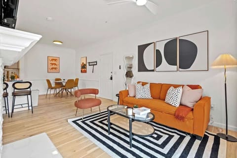 Bright living room with stylish decor, comfy seating, and large windows that fill the space with natural light. Perfect for relaxing or enjoying movie nights.