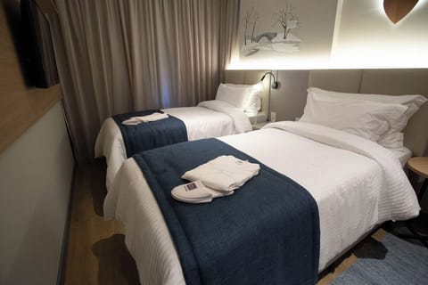 Drift off comfortably in twin beds with soft, hotel-style linens.