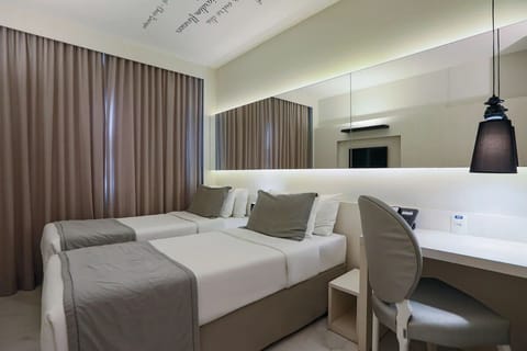 Unwind in twin beds with soft linens and calm lighting.