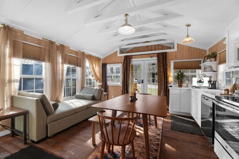 The open concept space features a fully equipped kitchen, along with a dining area and a living room