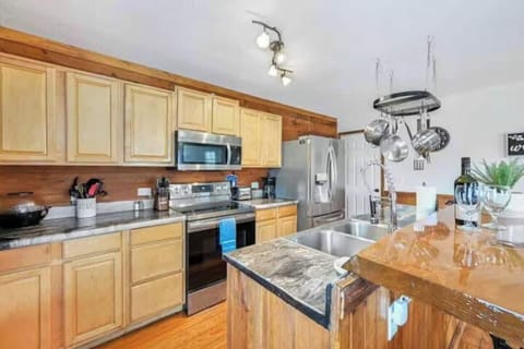 Fully equipped kitchen with modern appliances and cookware.