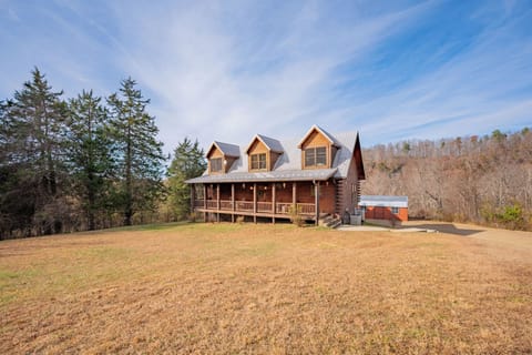 Charming log home with front porch and open yard