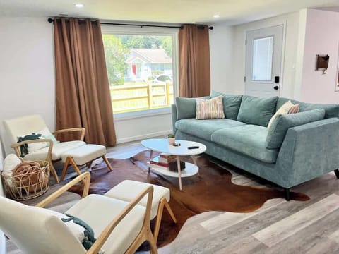 Comfortable pull out sofa, chairs, and a mounted 65 in smart television! 