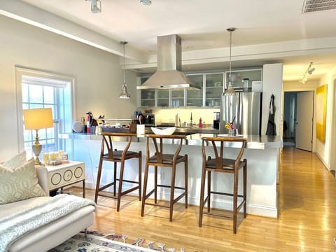 Stainless steel kitchen with Bosch dishwasher, new fridge, coffee maker, microwave, and fully stocked for cooking/eating