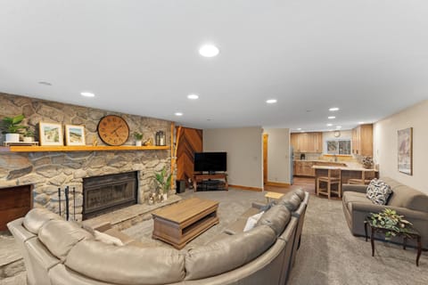 The living area features a wood-burning fireplace, TV, and queen sleeper sofa.