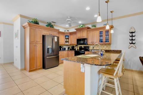 Your fully equipped kitchen features granite counters, stainless appliances, and a breakfast bar perfect for morning coffee.