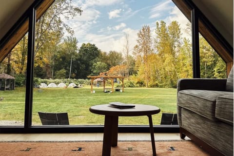 Relax with coffee as panoramic meadow views fill the room.