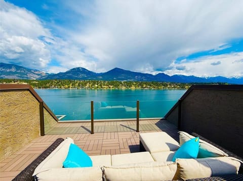Rooftop patio with outdoor furniture, dining area and stunning mountain & lake views.