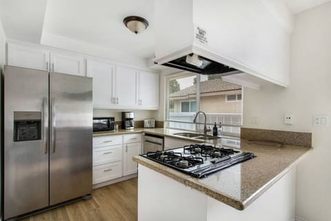 Fully stocked kitchen with modern appliances, gas stove, and drip coffee maker for your daily brew.